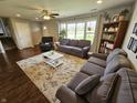 Inviting living room with hardwood floors, large window, neutral paint, comfortable sofas and a ceiling fan at 366 E 200 N, Franklin, IN 46131