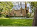 Beautiful brick home with a well-manicured lawn and mature trees at 4151 N Pennsylvania St, Indianapolis, IN 46205