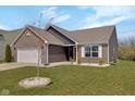 Lovely home with brick and siding, green lawn, and landscaping, offering great curb appeal at 4323 Stubbington Ln, Indianapolis, IN 46239