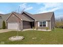 Beautiful home with a well-kept lawn, brick accents, and charming curb appeal at 4323 Stubbington Ln, Indianapolis, IN 46239