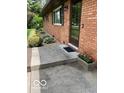 Inviting front entrance with brick facade, a blooming flower box, and manicured landscaping at 4329 Dudley N Dr, Indianapolis, IN 46237