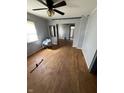 Spacious living room featuring hardwood floors, a ceiling fan, and plenty of natural light at 434 N 18Th Ave, Beech Grove, IN 46107