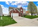 Charming two-story home with a brick facade, attached garage, and a basketball hoop at 4546 Creighton Ln, Indianapolis, IN 46237