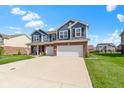 Gorgeous blue two-story home featuring a two-car garage, brick accents, and a well-maintained lawn in a lovely neighborhood at 4638 W Otway Ln, New Palestine, IN 46163