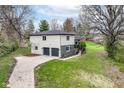 Aerial view of two-story home with a two-car garage, a concrete driveway and green lawn at 5302 E 46Th St, Indianapolis, IN 46226