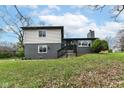 Charming two-story home featuring a combination of brick and siding, complemented by a well-maintained lawn and landscaping at 5302 E 46Th St, Indianapolis, IN 46226