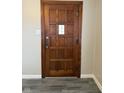Classic wooden front door with a paneled design and vintage hardware at 5428 Speedway Dr, Indianapolis, IN 46224
