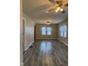 Spacious living room with ceiling fans and ample natural light from the windows at 5428 Speedway Dr, Indianapolis, IN 46224