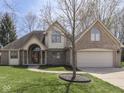 Inviting two-story brick home featuring an attached garage and a well-kept lawn at 5461 Steven Dr, Greenwood, IN 46142