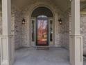 Inviting brick front porch with classic lantern lighting and a welcoming door at 5461 Steven Dr, Greenwood, IN 46142