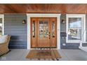 Inviting front porch featuring a wooden ceiling and door, with a cozy welcome mat at 5619 Carrollton Ave, Indianapolis, IN 46220