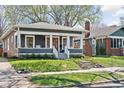 A quaint single Gathering home shows fresh landscaping, inviting front porch, and mature trees at 5619 Carrollton Ave, Indianapolis, IN 46220