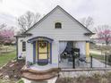 Charming home featuring a covered porch and colorful accents, creating a welcoming entrance at 57 Worman St, Indianapolis, IN 46227