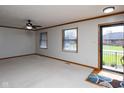 Spacious living room featuring neutral carpet, trim, and a ceiling fan at 572 Eagle Crest Dr, Brownsburg, IN 46112