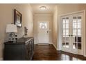Warm foyer with hardwood floors, elegant lighting, and a stylish console table at 5869 Belchamp Dr, Noblesville, IN 46062