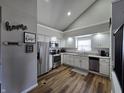 Bright kitchen with stainless steel appliances, wooden floors, and gray countertops at 599 Cielo Vista Dr, Greenwood, IN 46143