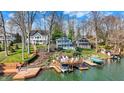 Picturesque lakefront property with charming blue two-story home, private docks, and scenic water views at 7003 Eagle Dr, Nineveh, IN 46164
