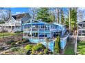 Charming two-story lake house with multiple decks, lush landscaping, and lake views creating a serene retreat at 7003 Eagle Dr, Nineveh, IN 46164