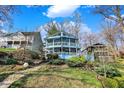 Charming blue two-story lake house with multiple decks and landscaped yard, ideal for peaceful lakeside living at 7003 Eagle Dr, Nineveh, IN 46164