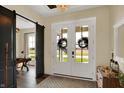 Bright entryway with white trim doors, decorative wreaths, and a view of the office space at 706 E 750 N, Lebanon, IN 46052
