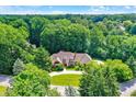 Stunning aerial view of the secluded home nestled among lush trees, with a circular driveway at 7545 Chablis Cir, Indianapolis, IN 46278