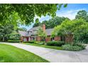 Attractive brick home with a red front door, chimney, and well-maintained lawn with landscaping at 7545 Chablis Cir, Indianapolis, IN 46278