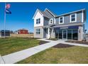 Charming two-story home featuring gray siding and a well-maintained lawn under a sunny sky at 7636 Big Bend Blvd, Camby, IN 46113