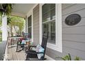 Inviting front porch with rocking chairs, a side table, and a plaque that reads 'The A D Hixon House' at 7638 Beekman Ter, Zionsville, IN 46077