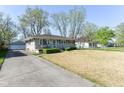 Inviting home exterior, driveway, and manicured front lawn at 7735 E 50Th St, Indianapolis, IN 46226