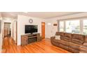 Cozy living area with hardwood flooring, faux fireplace, and natural light at 7735 E 50Th St, Indianapolis, IN 46226