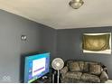 A cozy living room with gray paint, a TV, and a comfortable couch at 801 N Denny St, Indianapolis, IN 46201
