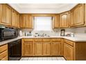 Traditional kitchen showcasing wood cabinets and a window over the sink at 8116 Heritage Commons Dr # Bldg 24, Indianapolis, IN 46219