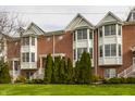 Classic brick townhome exterior with well-maintained lawn and greenery, showcasing timeless curb appeal at 861 S Park Trail Dr, Carmel, IN 46032