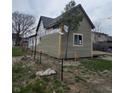 Side view of home featuring newly installed gray siding and new white trim at 1016 Dawson St, Indianapolis, IN 46203