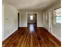 Inviting living room showcasing beautiful hardwood floors, neutral paint, and an open doorway to another room at 1020 N Colorado Ave, Indianapolis, IN 46201