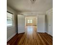 Bright living room featuring hardwood floors, white trim, and natural light streaming through the windows at 1020 N Colorado Ave, Indianapolis, IN 46201