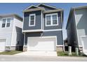 A well-maintained two-story home showcases a garage, siding, and well-kept landscaping at 1099 Valentine Ln, Carmel, IN 46032