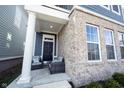 Charming front porch featuring a brick facade, stylish seating, and a welcoming entrance at 1099 Valentine Ln, Carmel, IN 46032