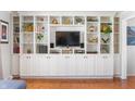 Living room with a built-in shelving unit featuring ample storage and display space at 1109 Oakwood Trl, Indianapolis, IN 46260
