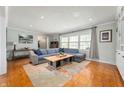 Bright living room with a large sectional sofa, area rug, and natural light from large windows at 1109 Oakwood Trl, Indianapolis, IN 46260