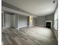 Open-concept living area with fireplace, grey paint, and staircase at 11152 Dura Dr, Indianapolis, IN 46229