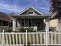 Traditional bungalow with a white picket fence and manicured front lawn at 1140 Hoyt Ave, Indianapolis, IN 46203