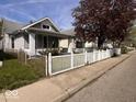 Cozy bungalow with a classic picket fence, landscaping, and a charming curb appeal at 1140 Hoyt Ave, Indianapolis, IN 46203