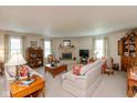 Bright living room with a stone fireplace, neutral tones, and large windows at 14195 Holly Berry Cir, Fishers, IN 46038
