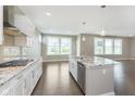 Open kitchen with granite island, stainless appliances, and hardwood floors perfect for entertaining at 14878 Horse Branch Way, Fishers, IN 46040