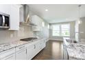 Bright kitchen with stainless steel appliances, granite counters, and a view of the backyard at 14878 Horse Branch Way, Fishers, IN 46040