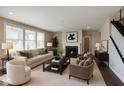 Bright living room features a fireplace, large windows, and neutral decor at 14878 Horse Branch Way, Fishers, IN 46040