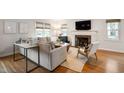 Bright living room with a cozy fireplace, plush sofa, and hardwood floors at 171 W 44Th St, Indianapolis, IN 46208