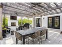 Charming patio featuring a wooden pergola, outdoor seating, a fireplace, and a grill for outdoor entertainment at 222 E 71St St, Indianapolis, IN 46220