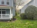 View of a side yard featuring a lush lawn and a light blue house with white trim at 2250 N Capitol Ave, Indianapolis, IN 46208